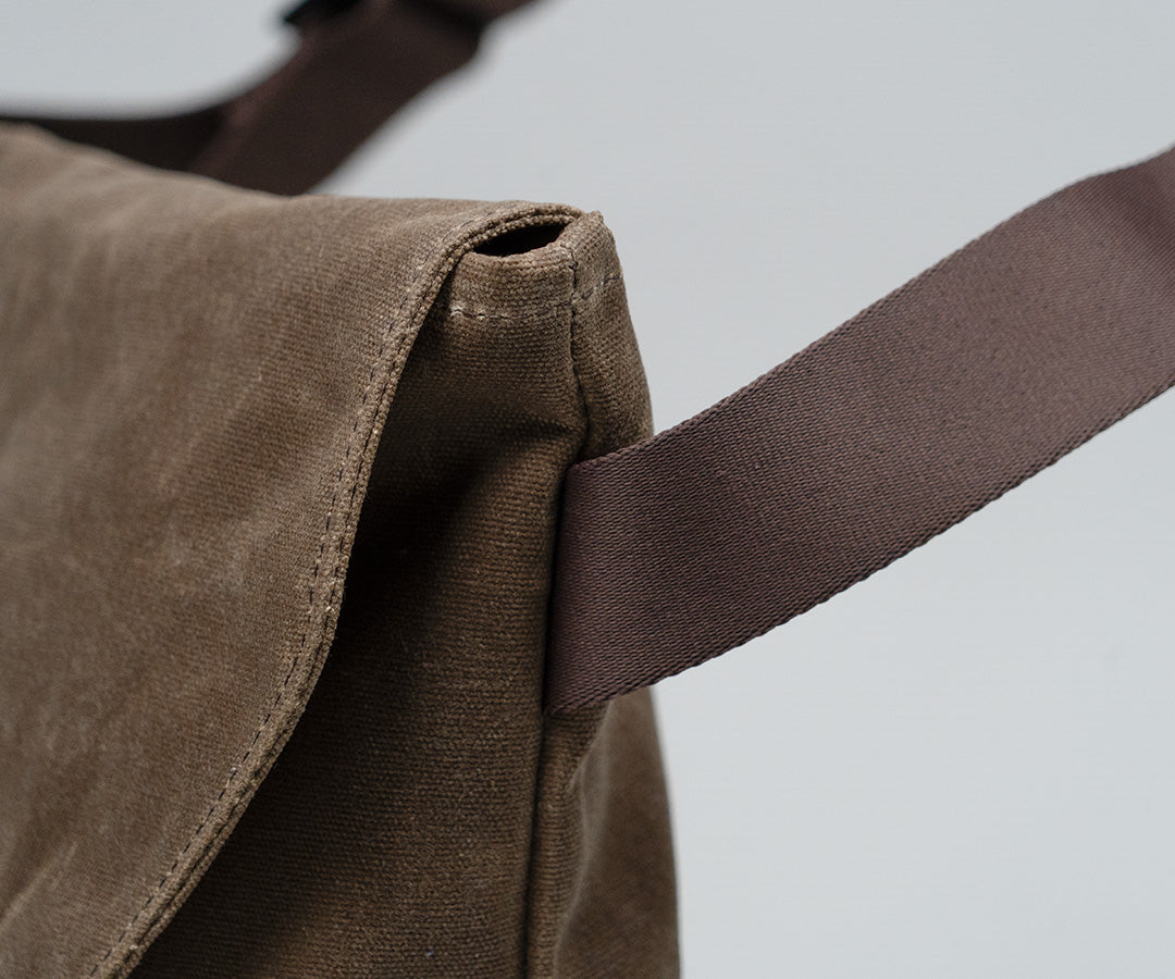 Angled strap attachment for enhanced comfort