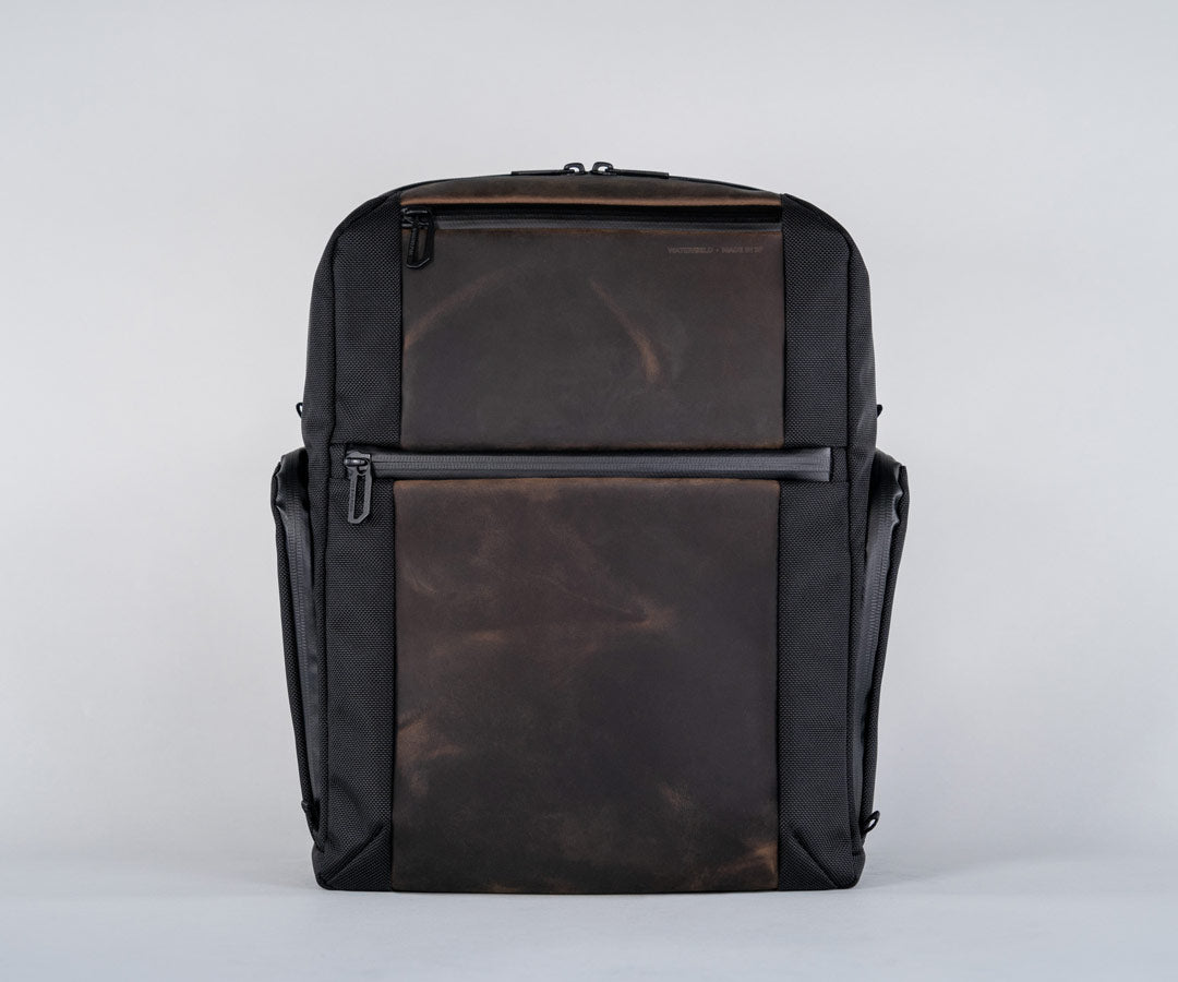 Front panel has two full-grain leather pockets for easy access