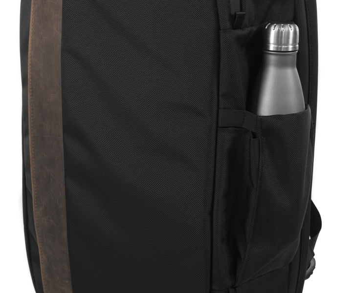 Side water bottle pocket expands as needed